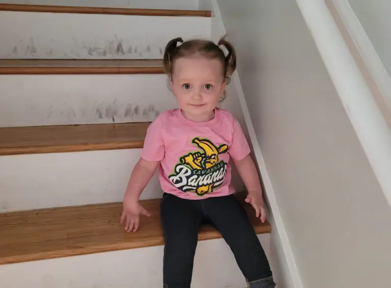 Clara sitting calmly on stairs